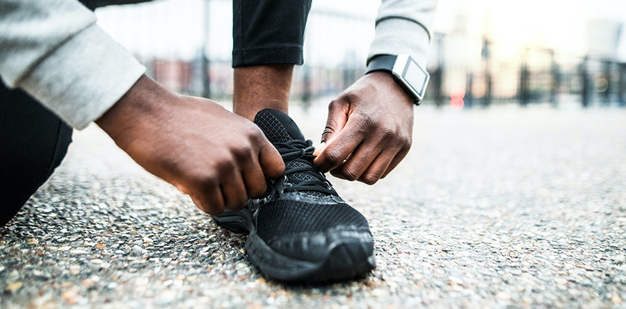 man tying his black shoe