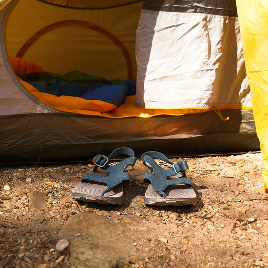 Pair of Men's Albion Sandals by a yellow tent