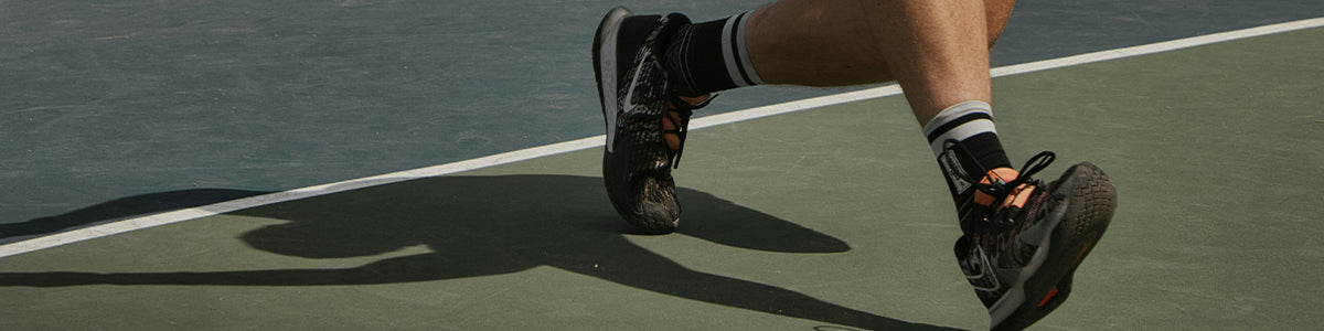 Closeup of man's shoes while playing pickleball with Tread Labs insoles in his shoes