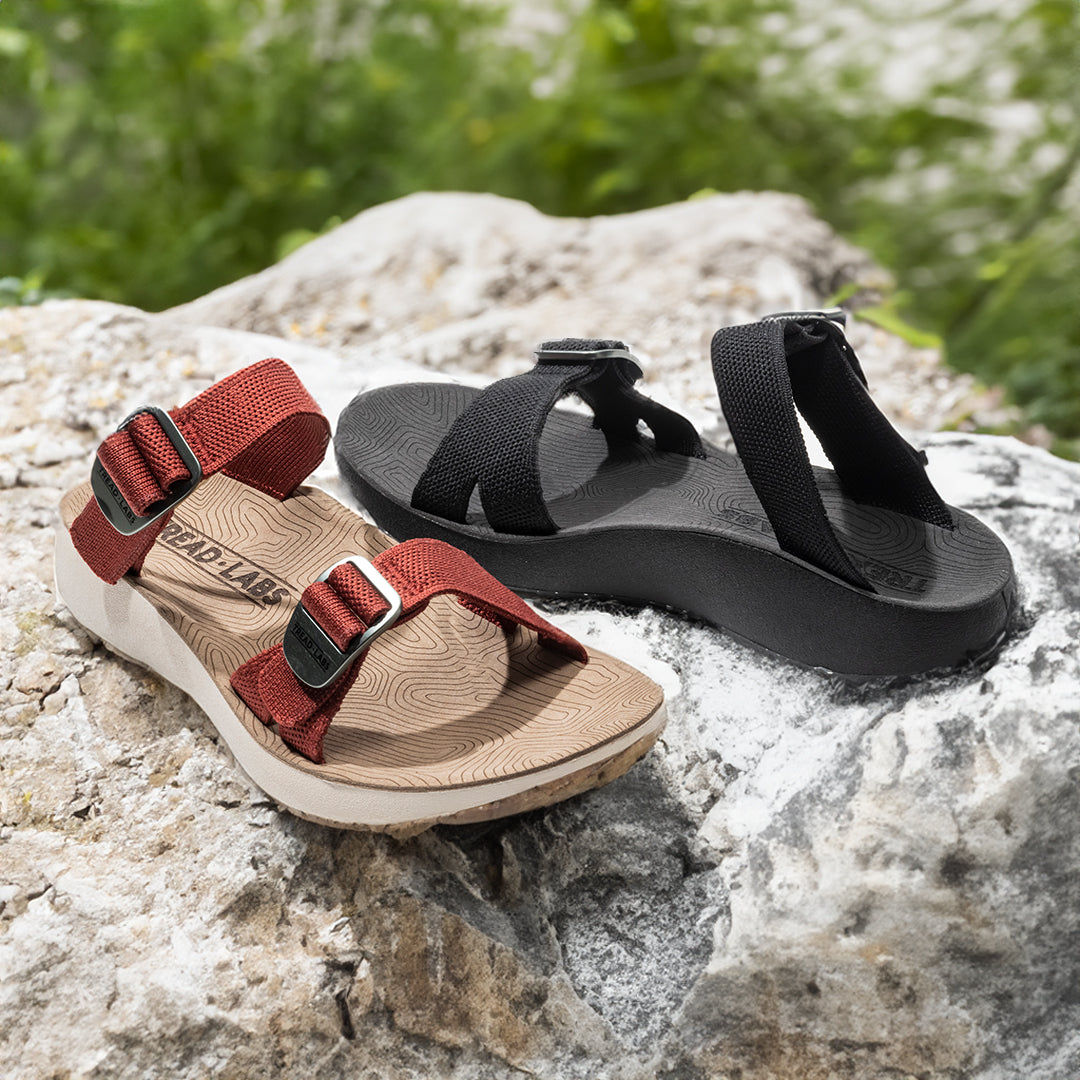 Salinas Slide Sandals sitting on a rock outside.