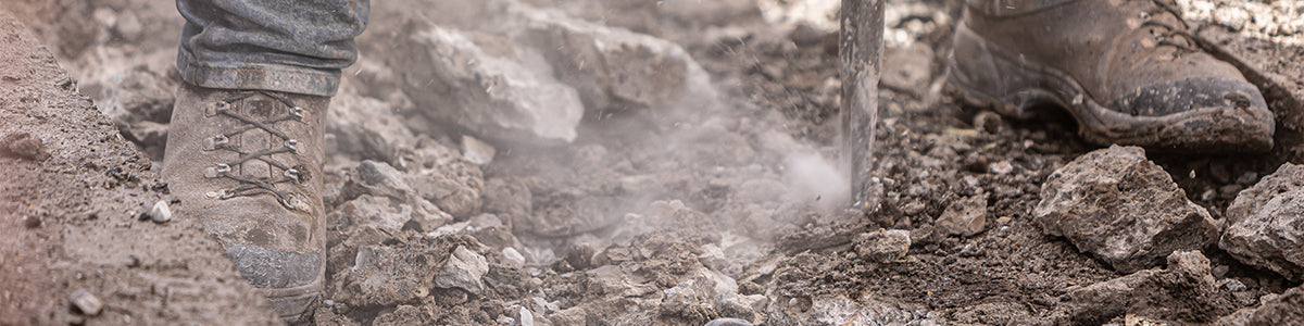 Closeup of work boots on rubble at a construction site