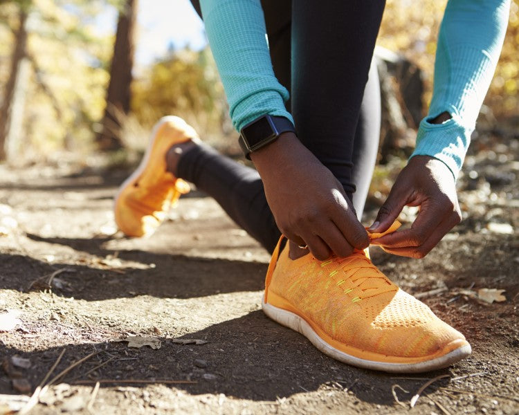 Woman tying shoelace on a running sneaker