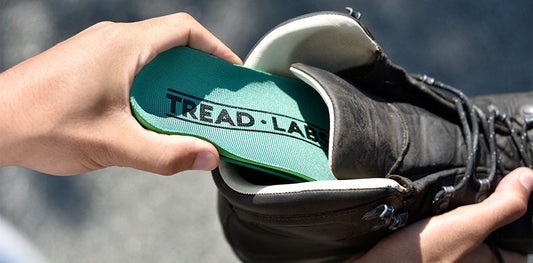 Tread Labs insole being inserted into boot.