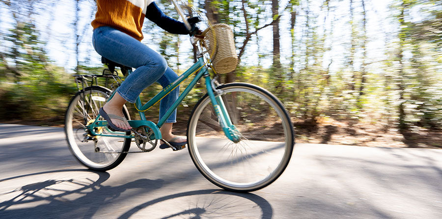 Woman wearing sandals while riding a bike