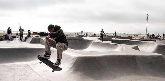 A man doing a trick on a skateboard at a skate park.