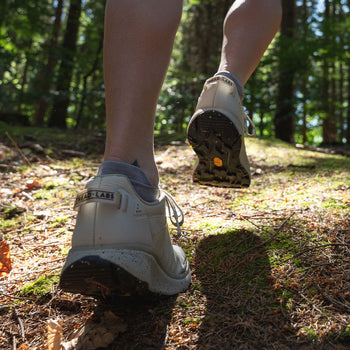 close-up of a woman hiking up a hill