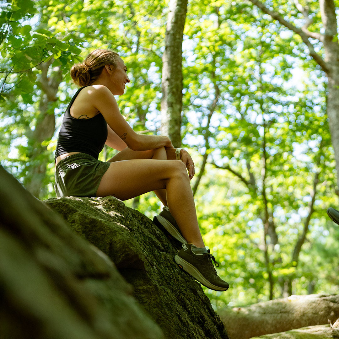 Woman sitting on a rock in a forest