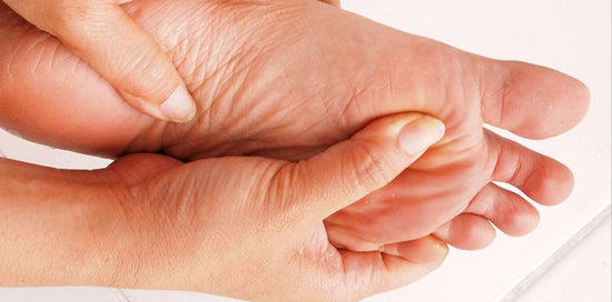 Closeup of a person massaging their forefoot to find relief from Morton's Neuroma