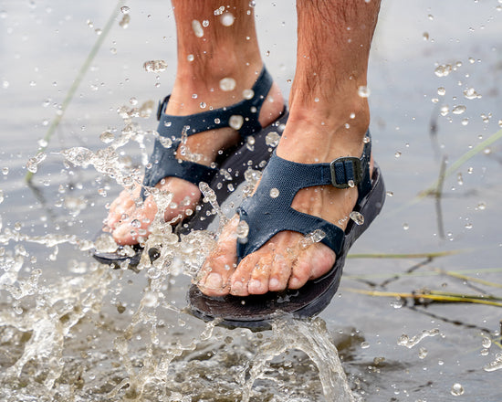 Man wearing Albion Sandals splashing in the river
